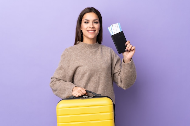 Young caucasian woman with suitcase and passport