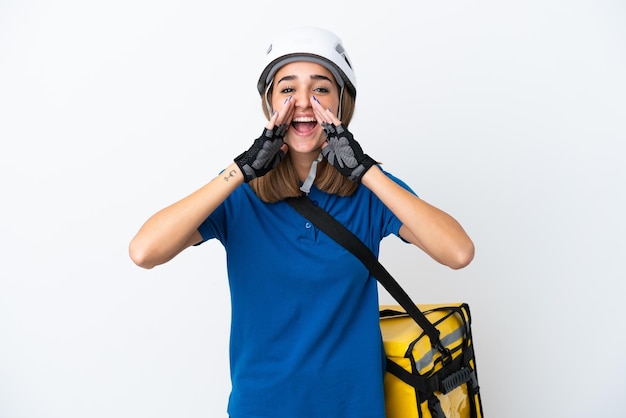 Young caucasian woman with thermal backpack isolated on white background shouting and announcing something