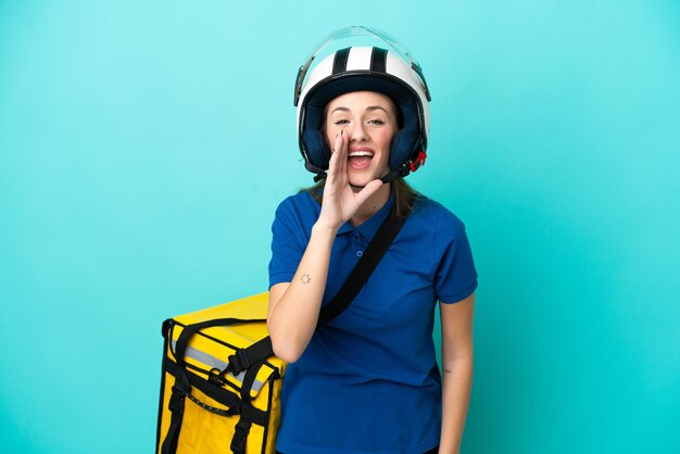 Young caucasian woman with thermal backpack isolated on white background shouting with mouth wide open