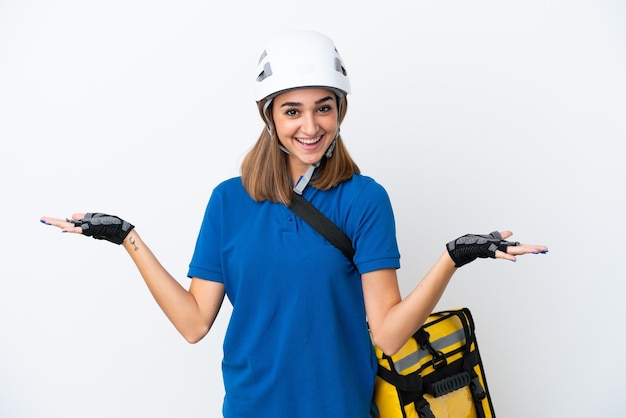 Young caucasian woman with thermal backpack isolated on white background with shocked facial expression