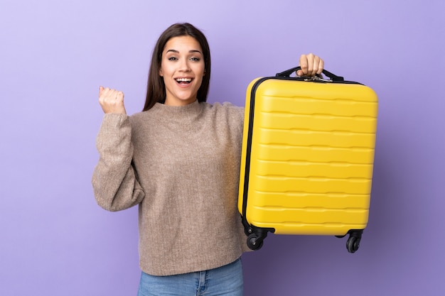 Young caucasian woman with travel suitcase