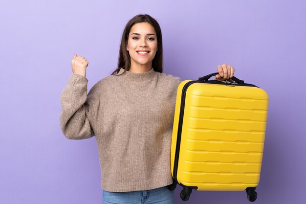 Young caucasian woman with travel suitcase