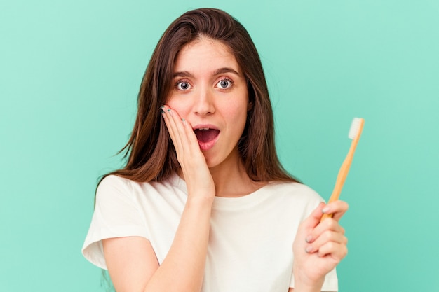 Young caucasian women holding a toothbrush isolated