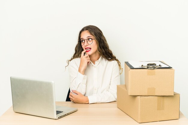 Young caucasian worker of a parcel company isolated