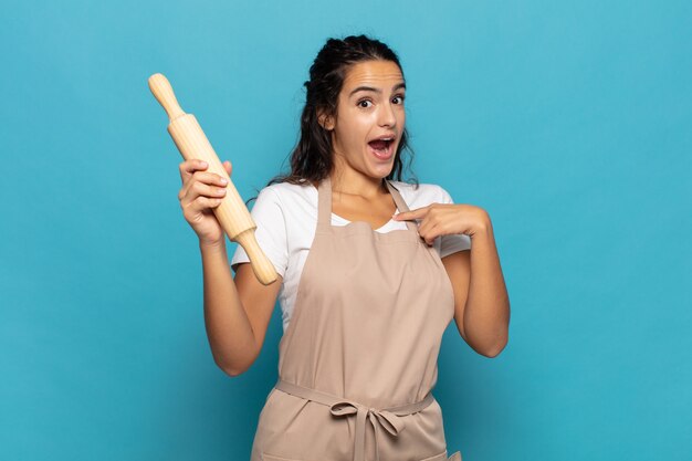 Young caucasic woman feeling happy, surprised and proud, pointing to self with an excited, amazed look