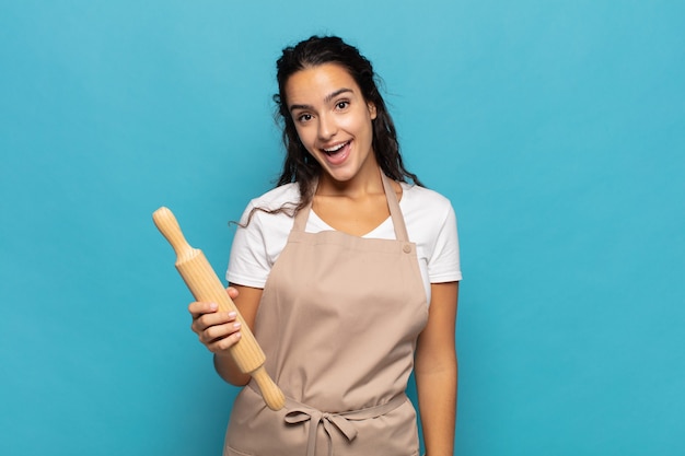 Young caucasic woman looking happy and pleasantly surprised, excited with a fascinated and shocked expression