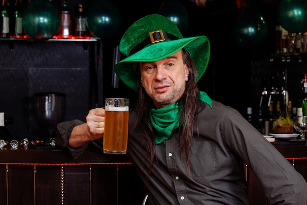 Young celebrate patrick day fun bar carnival headgear girl man\
beer cocktail green clothes hat smile beautiful leprechaun