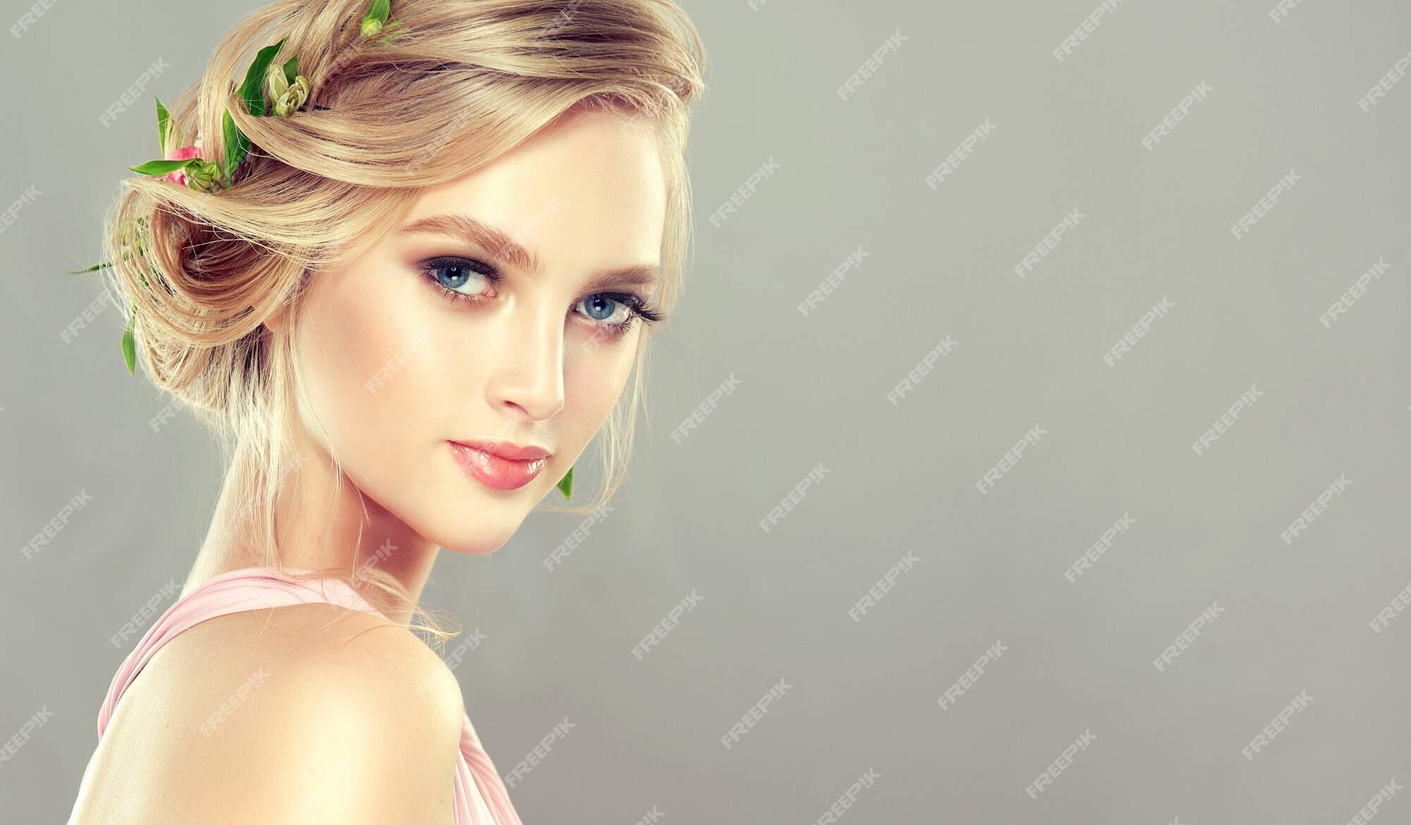 Premium Photo | Young, charming, blue eyed model with blonde hair gathered  in elegant hairstyle with fresh flowers. hairdressing art, coloration of  hair and beauty products.