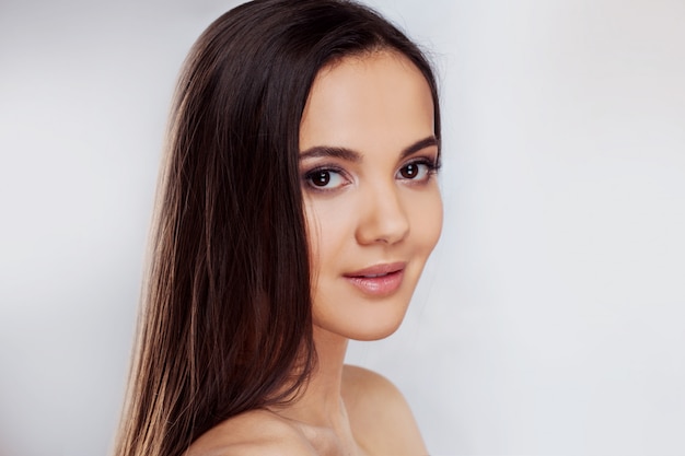 Young charming brunette smiling. Beauty portrait of a young beautiful woman