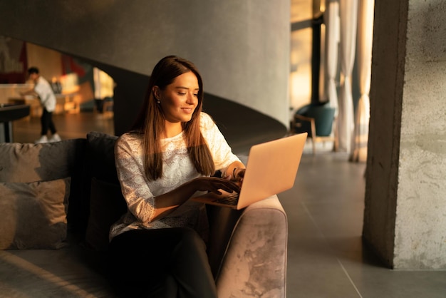 The young charming business woman at the laptop