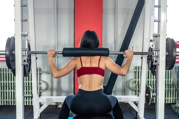 Young charming girl with perfect skin trainer monitors her body and fitness