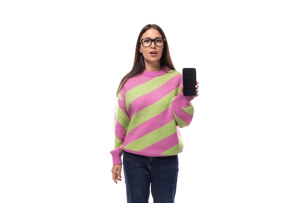 Young cheerful charming caucasian woman with straight black hair dressed in stylish autumn striped