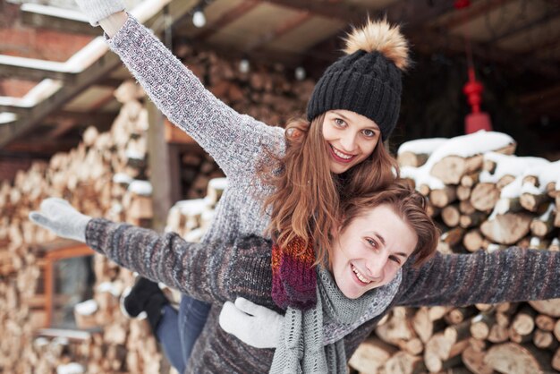 Young cheerful couple in a cabin in romantic scape in winter