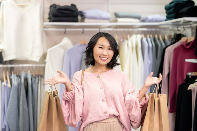 Premium Photo  Young cheerful female shopaholic in smart