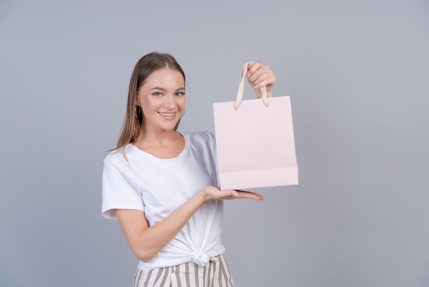 Young cheerful woman happy positive smile hold bag package buy customer sale