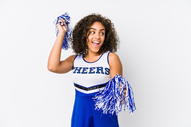 Young cheerleader woman isolated on white 