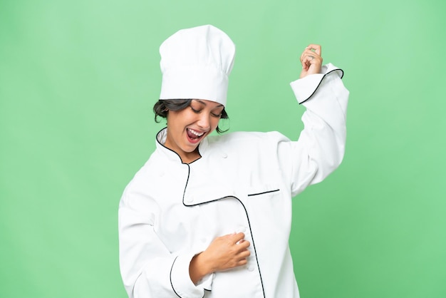Young chef Argentinian woman over isolated background making guitar gesture