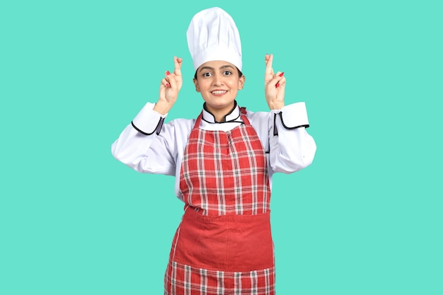 young chef girl front pose over green background indian pakistani model