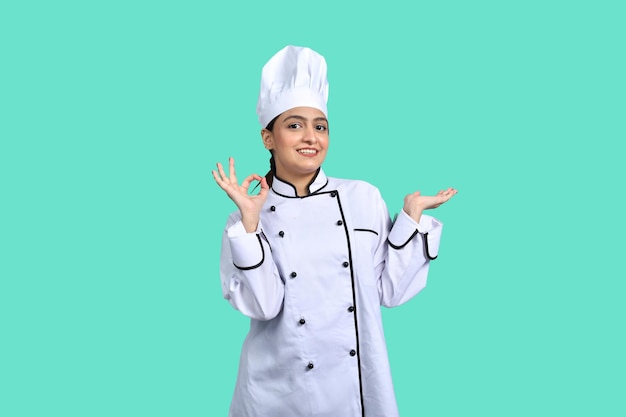 young chef girl front pose with ok sign white outfit indian pakistani model