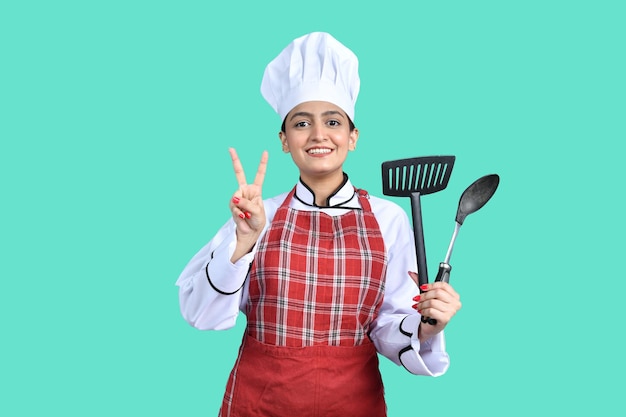 young chef girl white outfit having tools indian pakistani model