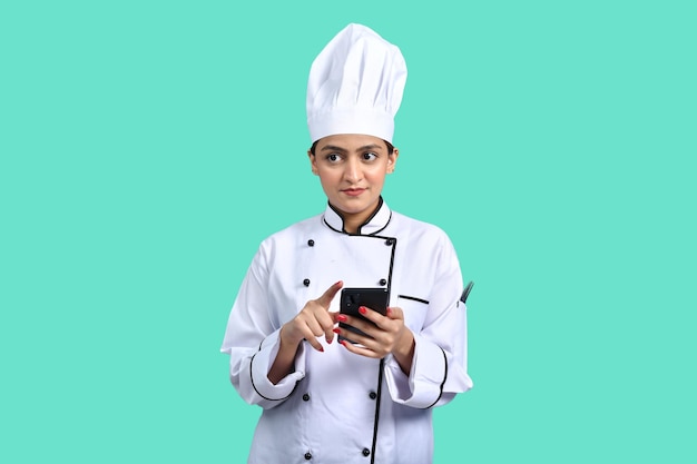 young chef girl white outfit using smart phone indian pakistani model