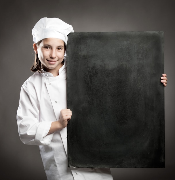 young chef holding menu chalkboard