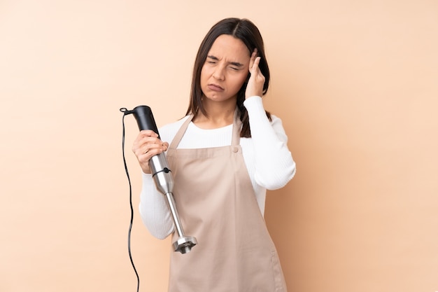 Young chef over isolated background