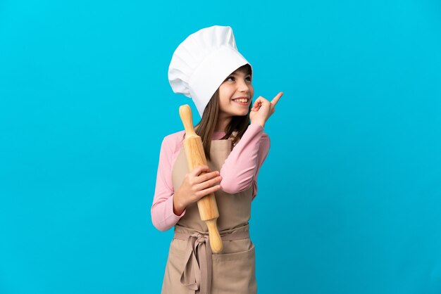 Young chef over isolated background