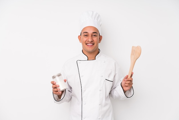 Young chef latin man cooking