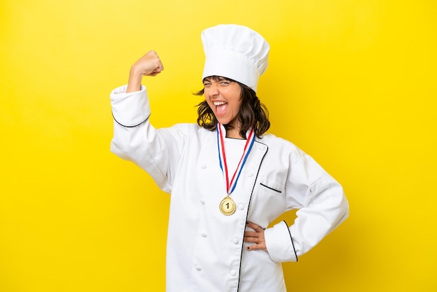 Young chef latin woman isolated on yellow background