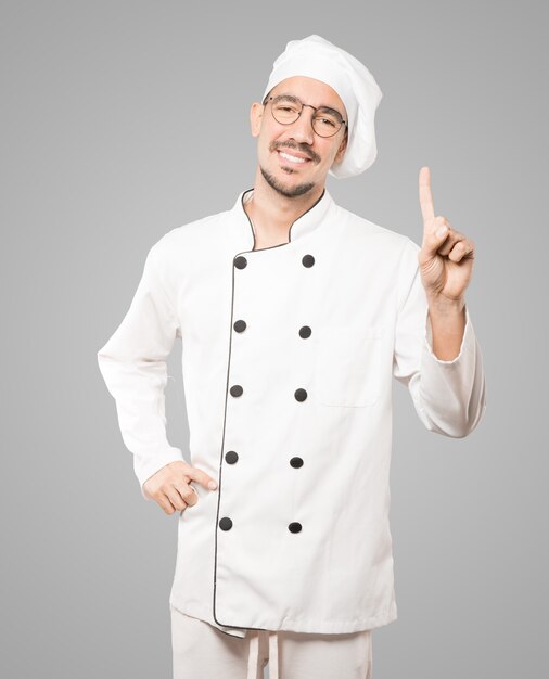 Young chef making a number one gesture