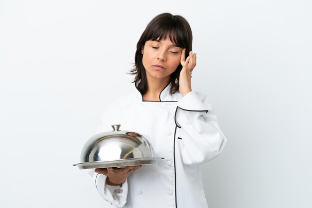 Young chef with tray isolated on white background with headache