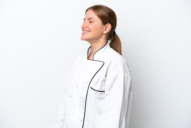 Young chef woman isolated on white background laughing in lateral position