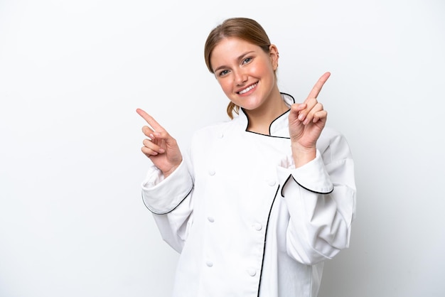 Young chef woman isolated on white background pointing finger to the laterals and happy