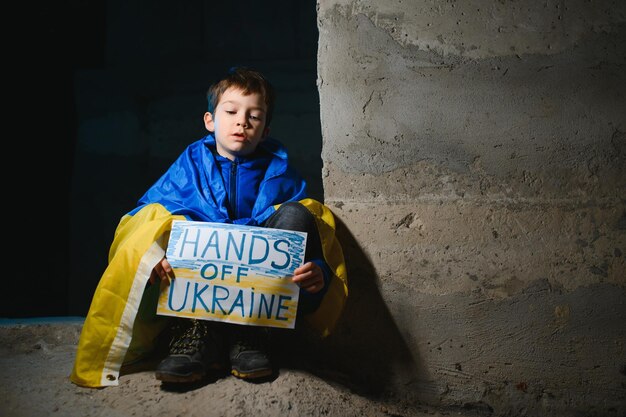 Young child holding sign in support to peace no war wanted kid wishing peaceful life Picture in connection with the continuing war in Ukraine