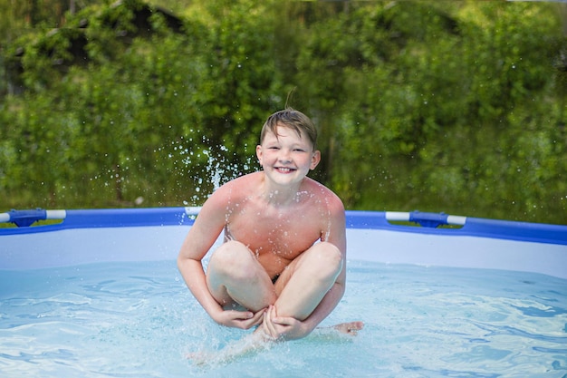 A young child jumping into a pool with splashes in clear water on a sunny summer