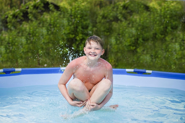 A young child jumping into a pool with splashes in clear water\
on a sunny summer