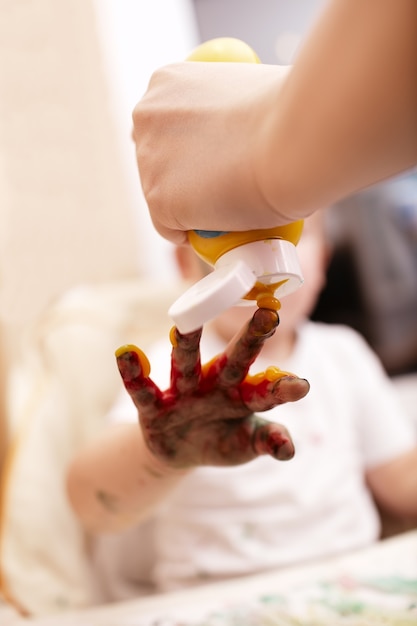 Young child playing with finger paint