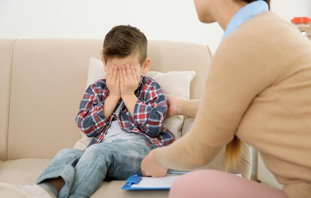 Young child psychologist working with little boy