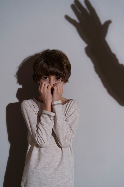 Photo young child suffering abuse with shadow