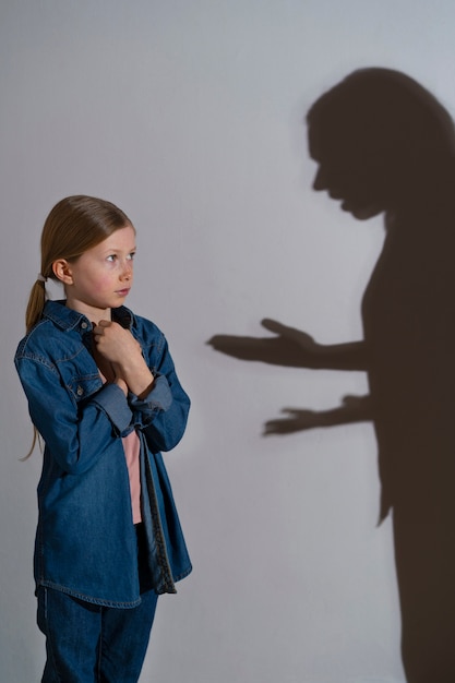 Photo young child suffering abuse with shadow