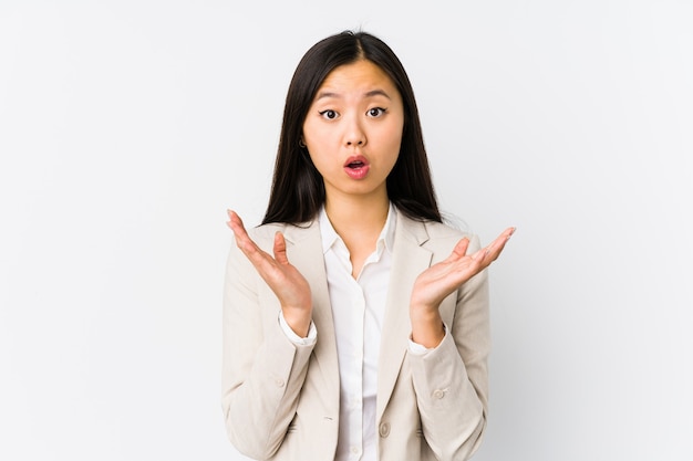 Young chinese business woman isolated surprised and shocked.