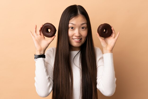 Young Chinese girl holding donuts