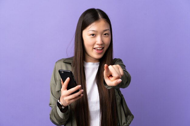 Young Chinese girl using mobile phone isolated