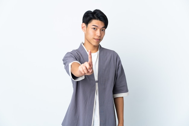 Young Chinese man over isolated showing and lifting a finger