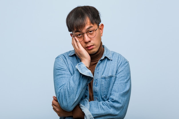 Young chinese man tired and very sleepy