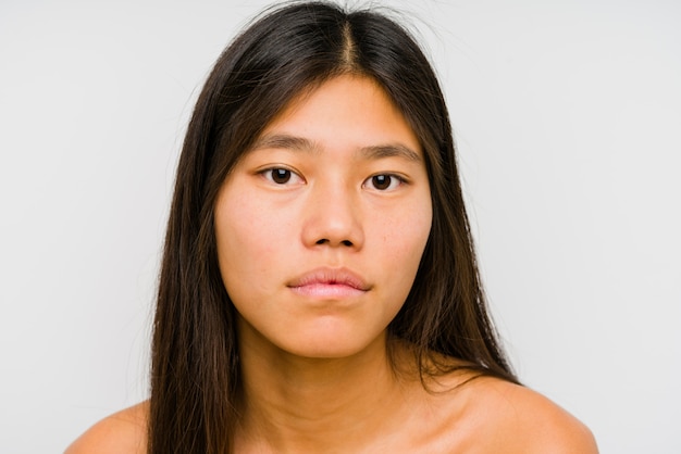 Young chinese woman face close up isolated