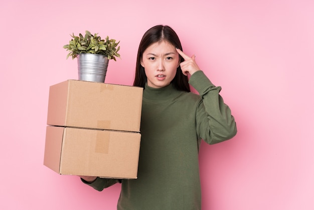 Young chinese woman holding boxes