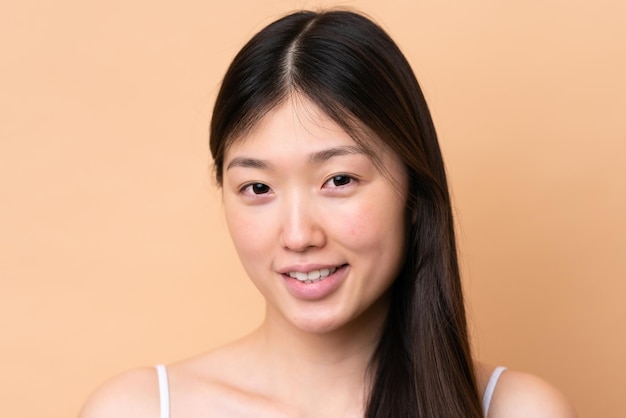 Young Chinese woman isolated on beige background Portrait