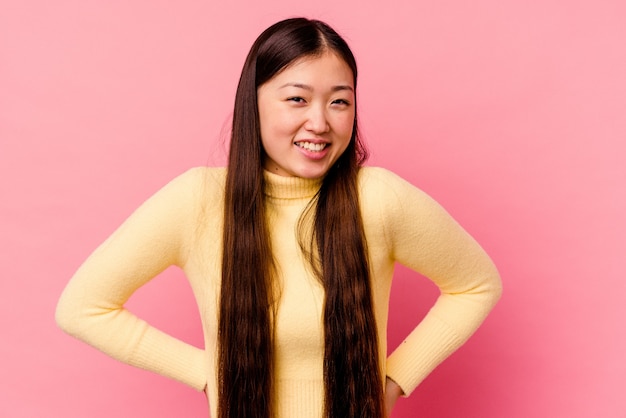 Young chinese woman isolated on pink happy, smiling and cheerful.